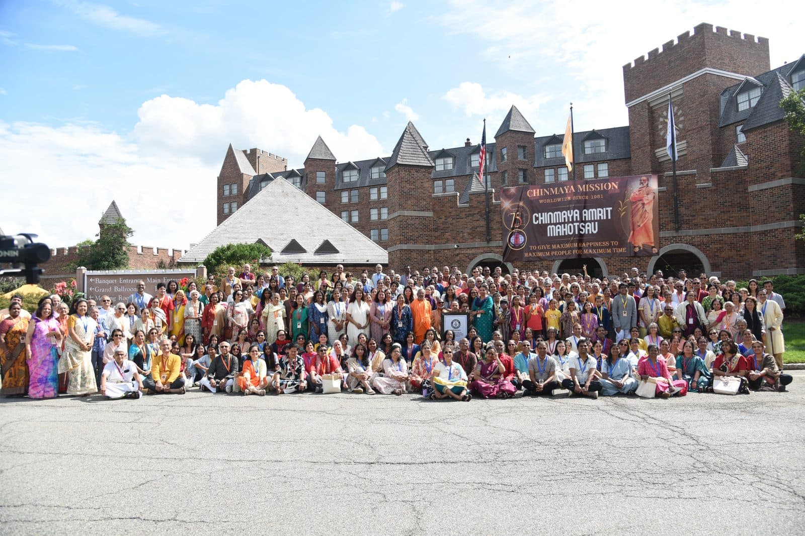 Chinmaya Mission members gathered outside the Chinmaya Amrit Mahotsav, holding the Guinness World Records certificate